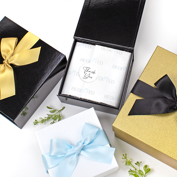 BEGIFTED group of gift boxes and ribbons in gold, white, black and Light Blue