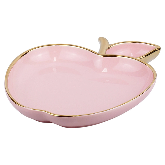 Pink ceramic dish shaped like an apple with gold rim on a white background. I