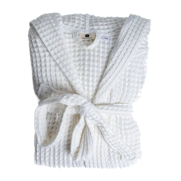 The Blissful Spa Gift Box featuring a white magnetic gift box, waffle weave robe, sweet dreams scented candles, bath salts, hand cream, bath brush, candle wick cutter, matches with gold embossed box, lavender scented body roll on, and faux plant in stone holder.