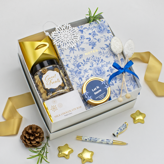 Gift set with a jar of treats, Blue floral printed journal, blue floral and gold pen, handmade soap, chocolate starts on white background. Chanukah Gift. Holiday Gift. Corporate Gift.