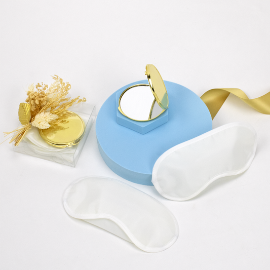 Welcome Guest Gift Box, featuring 2 white eye masks and gold compact mirror. 